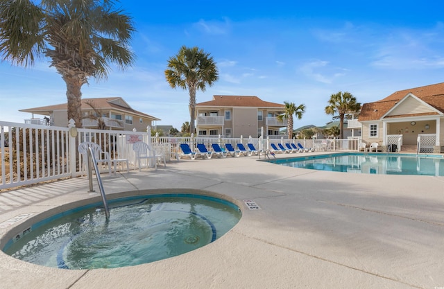 view of pool featuring a patio area and a hot tub