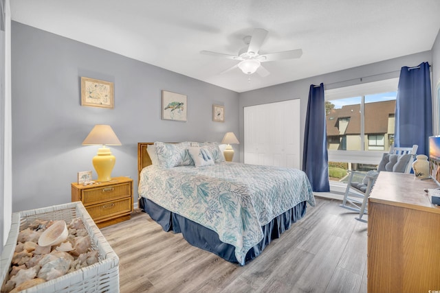 bedroom featuring ceiling fan, light hardwood / wood-style floors, and a closet