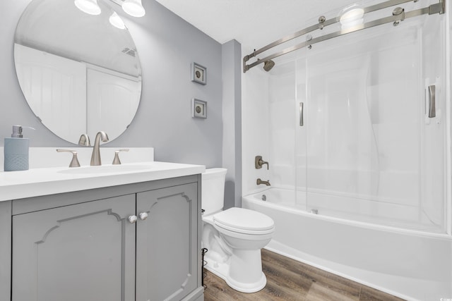 full bathroom with washtub / shower combination, vanity, toilet, and hardwood / wood-style floors