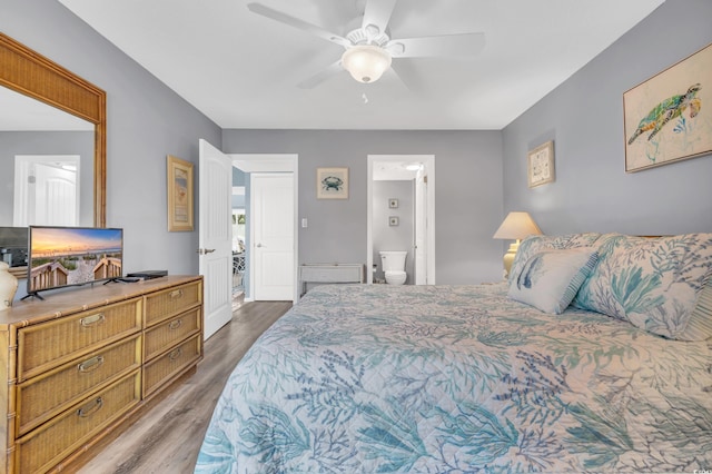 bedroom featuring ceiling fan, connected bathroom, and dark hardwood / wood-style flooring