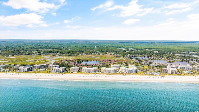 birds eye view of property with a water view and a beach view