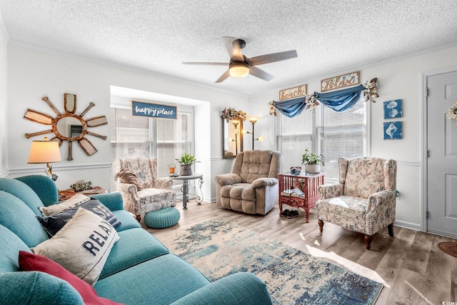 living room with hardwood / wood-style flooring, a healthy amount of sunlight, and a textured ceiling