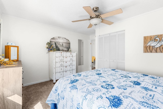 bedroom featuring a textured ceiling, ornamental molding, a closet, ceiling fan, and carpet