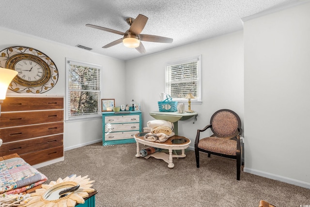 bedroom with ceiling fan, a textured ceiling, and dark colored carpet