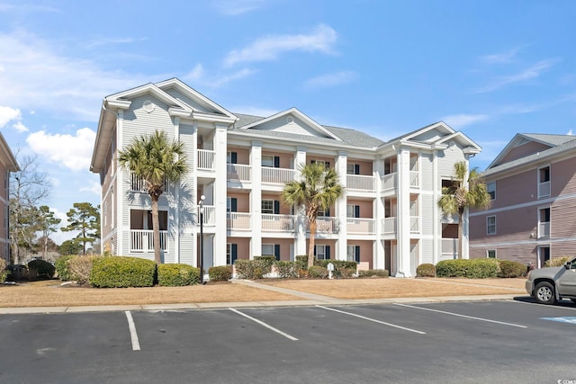 view of property featuring uncovered parking