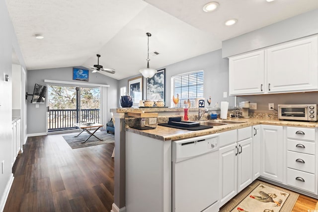 kitchen with white cabinetry, plenty of natural light, white dishwasher, decorative light fixtures, and vaulted ceiling