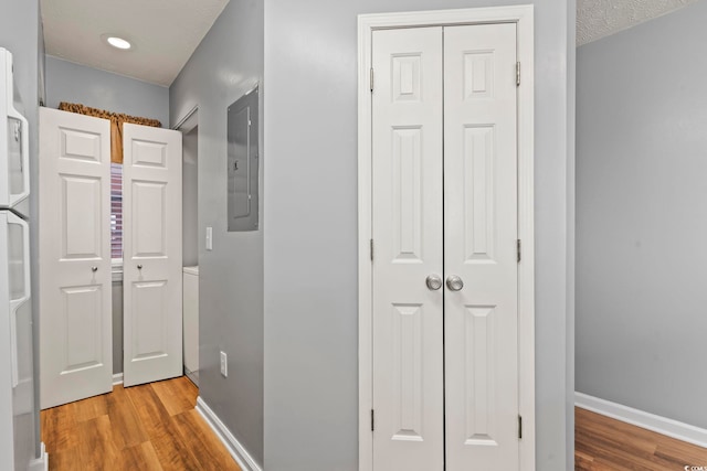 hallway with hardwood / wood-style floors