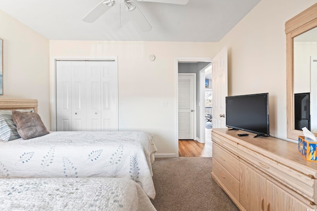 carpeted bedroom with ceiling fan and a closet