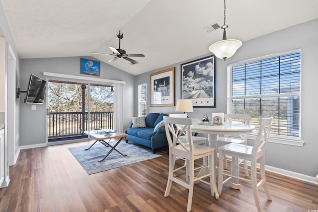 dining space featuring hardwood / wood-style floors, vaulted ceiling, a healthy amount of sunlight, and ceiling fan