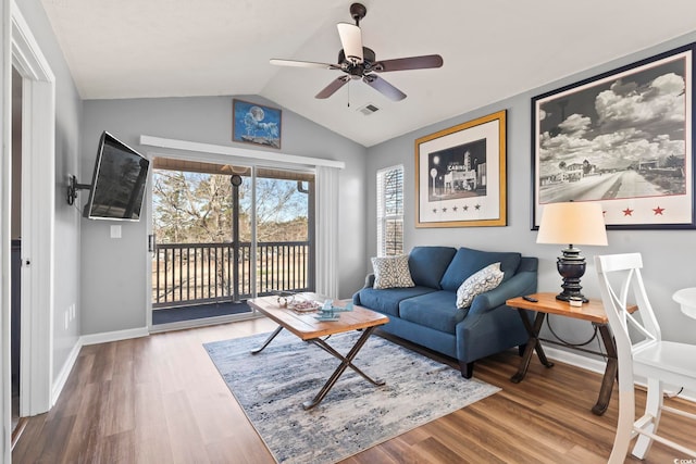 living room featuring vaulted ceiling, ceiling fan, and hardwood / wood-style floors