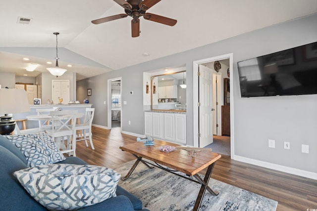 living room featuring ceiling fan, lofted ceiling, and dark hardwood / wood-style flooring