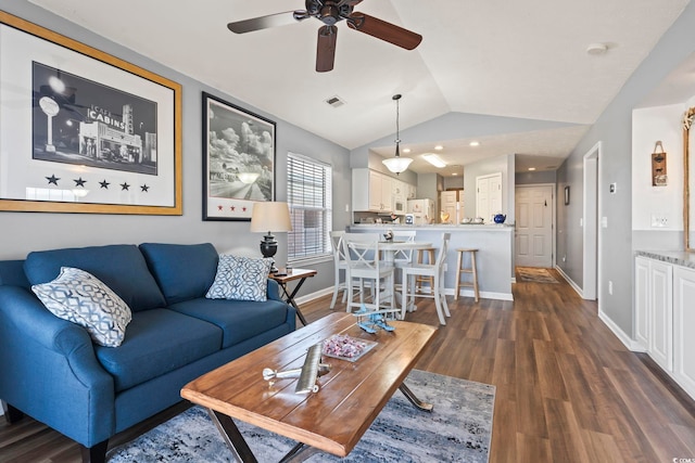 living room featuring vaulted ceiling, ceiling fan, and dark hardwood / wood-style flooring