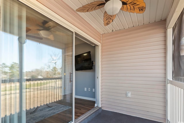 unfurnished sunroom featuring wooden ceiling and ceiling fan