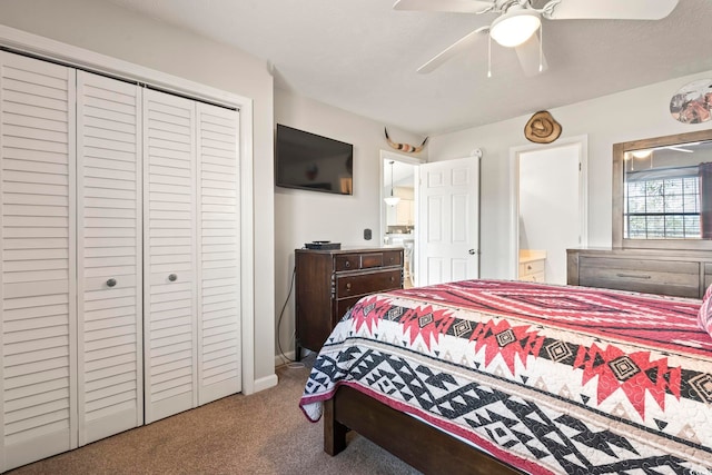 bedroom with ceiling fan, carpet flooring, and a closet