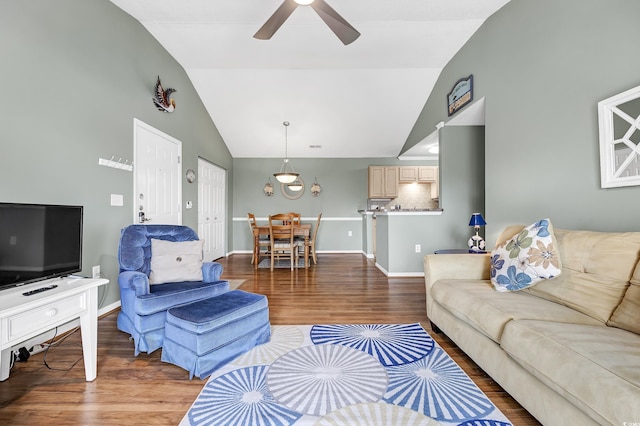 living room with hardwood / wood-style floors, high vaulted ceiling, and ceiling fan