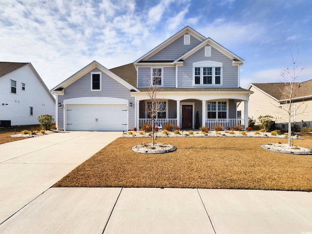 craftsman-style house featuring covered porch, driveway, and an attached garage