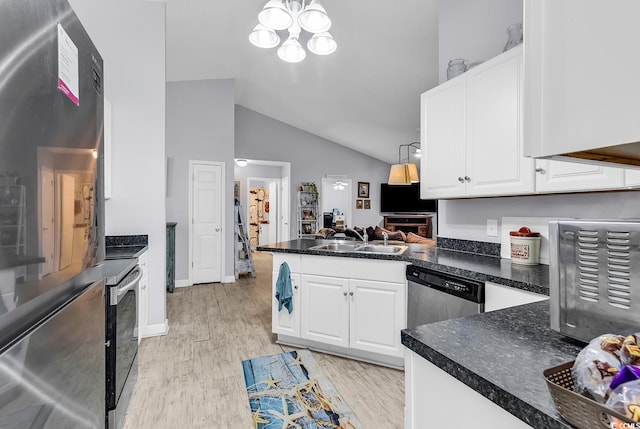 kitchen with stainless steel appliances, sink, white cabinets, and light hardwood / wood-style floors