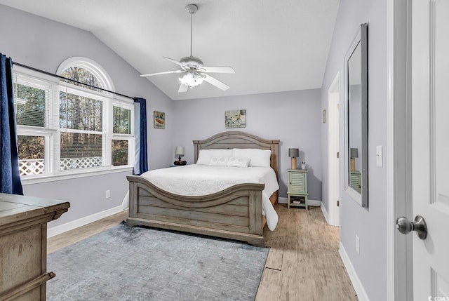 bedroom with lofted ceiling, light hardwood / wood-style flooring, and ceiling fan