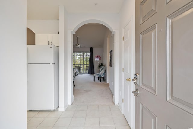 5825 Catalina Dr Unit 332, North Myrtle Beach, SC 29582 - hallway with light colored carpet, arched walkways, and light tile patterned floors