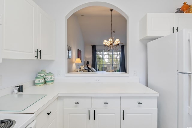 5825 Catalina Dr Unit 332, North Myrtle Beach, SC 29582 - kitchen with freestanding refrigerator, a chandelier, light countertops, white cabinets, and lofted ceiling
