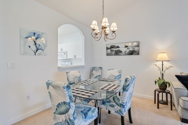 5825 Catalina Dr Unit 332, North Myrtle Beach, SC 29582 - dining space featuring light colored carpet, arched walkways, a chandelier, and vaulted ceiling