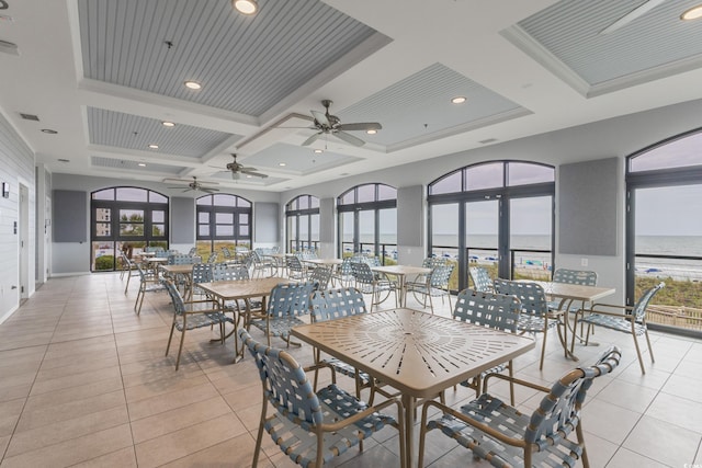 5825 Catalina Dr Unit 332, North Myrtle Beach, SC 29582 - dining room with coffered ceiling, ceiling fan, light tile patterned flooring, a water view, and beamed ceiling
