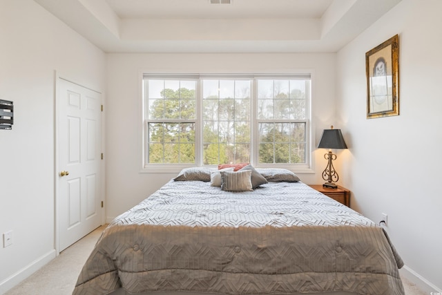 5825 Catalina Dr Unit 332, North Myrtle Beach, SC 29582 - bedroom featuring multiple windows, light colored carpet, and a raised ceiling