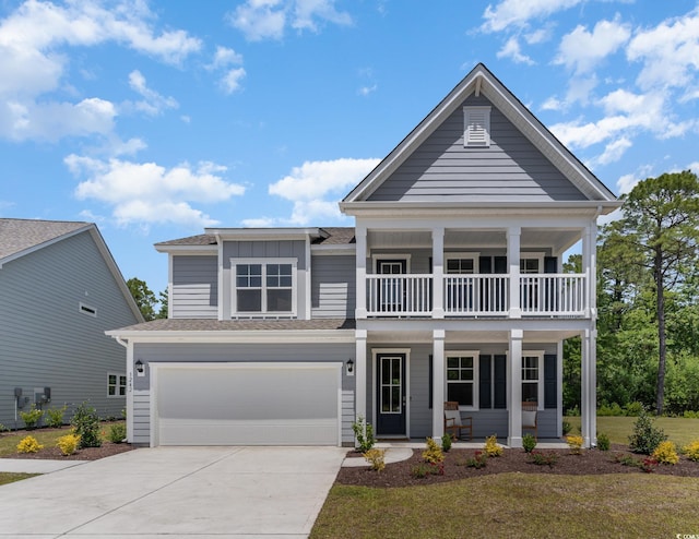 view of front facade with a garage, a front yard, a balcony, and a porch