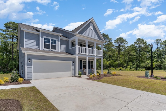 view of front of home featuring a balcony, a garage, and a front yard