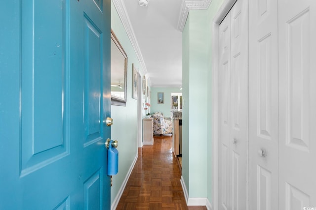 hallway featuring ornamental molding and dark parquet flooring