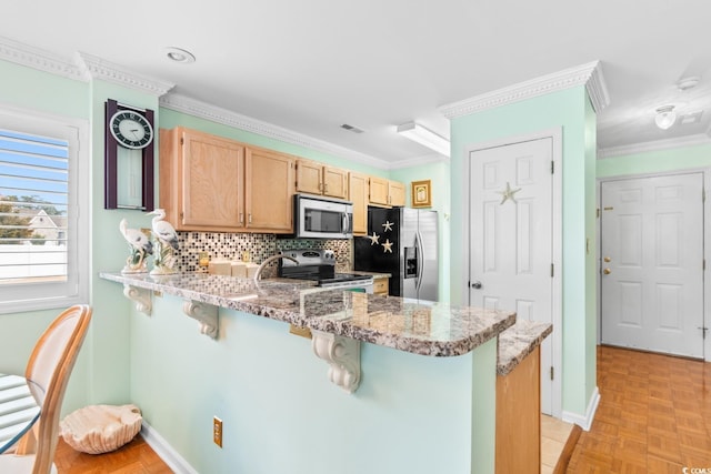 kitchen with a breakfast bar area, light stone counters, appliances with stainless steel finishes, kitchen peninsula, and light parquet floors