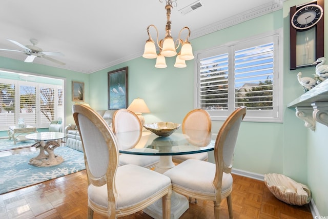 dining space featuring parquet floors, plenty of natural light, crown molding, and ceiling fan with notable chandelier