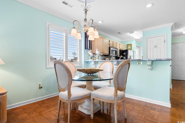 dining space featuring a notable chandelier, crown molding, and dark parquet floors