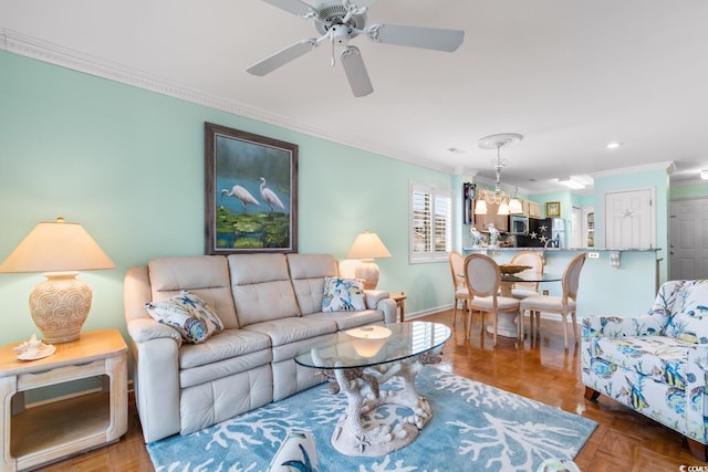 living room with parquet floors, ceiling fan with notable chandelier, and ornamental molding