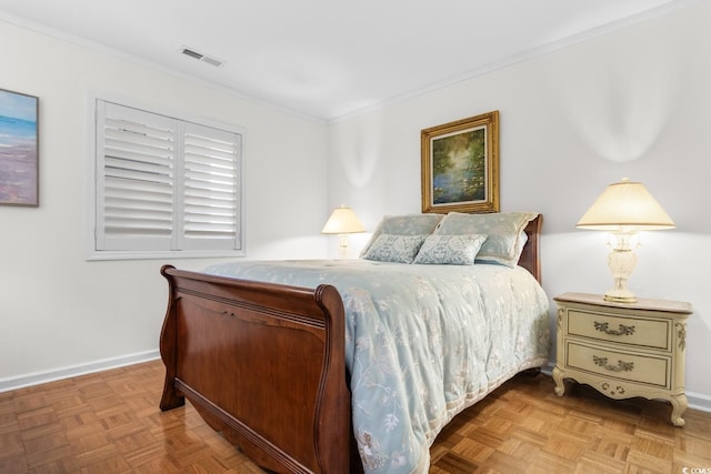 bedroom with crown molding and light parquet flooring