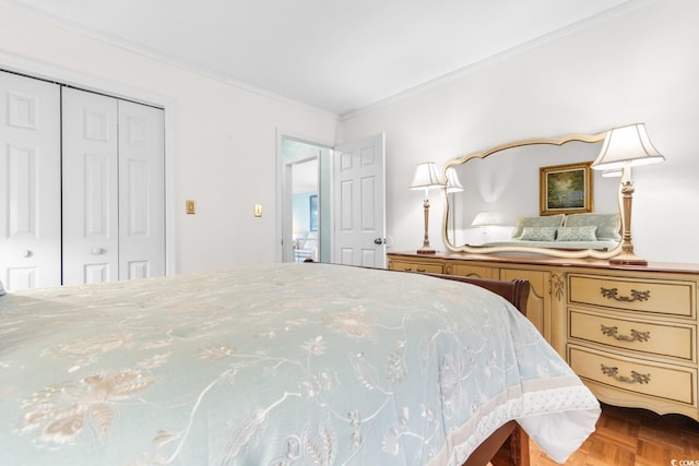 bedroom with ornamental molding, parquet floors, and a closet