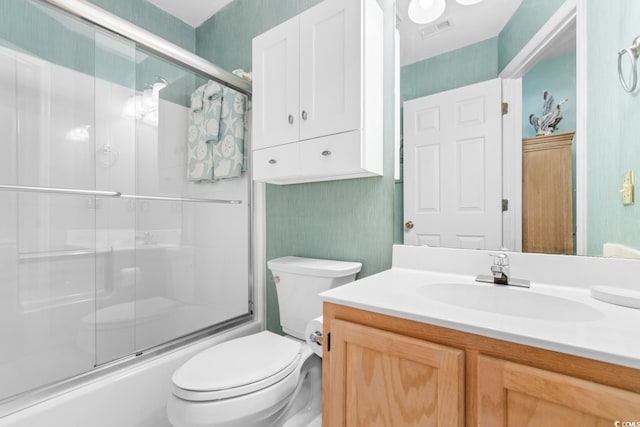 full bathroom with shower / bath combination with glass door, vanity, and toilet