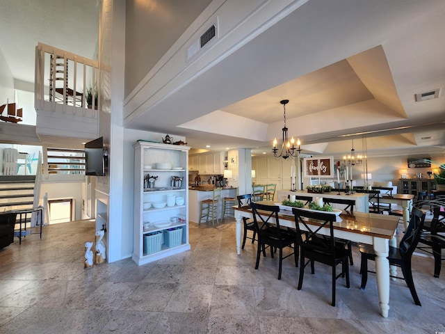 dining room featuring an inviting chandelier and a tray ceiling