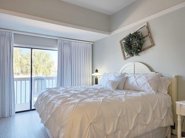 bedroom featuring access to exterior and light hardwood / wood-style flooring