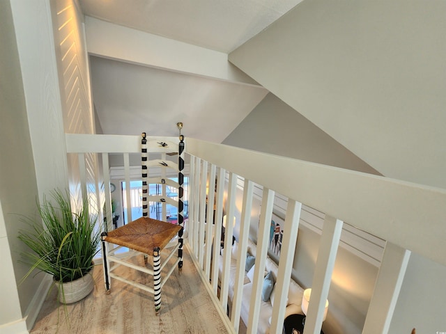 staircase featuring lofted ceiling and hardwood / wood-style floors