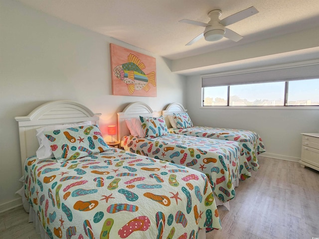 bedroom featuring light hardwood / wood-style flooring and ceiling fan