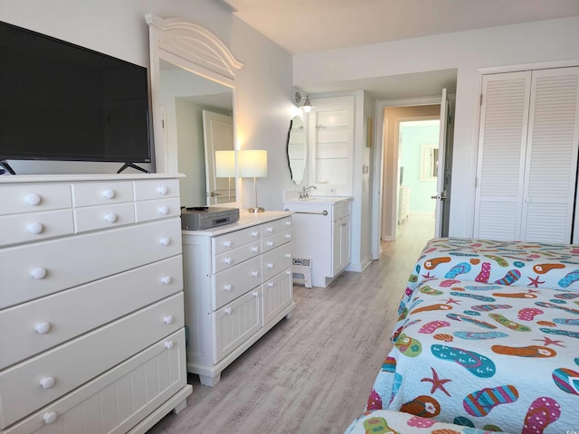 bedroom featuring a closet and light wood-type flooring