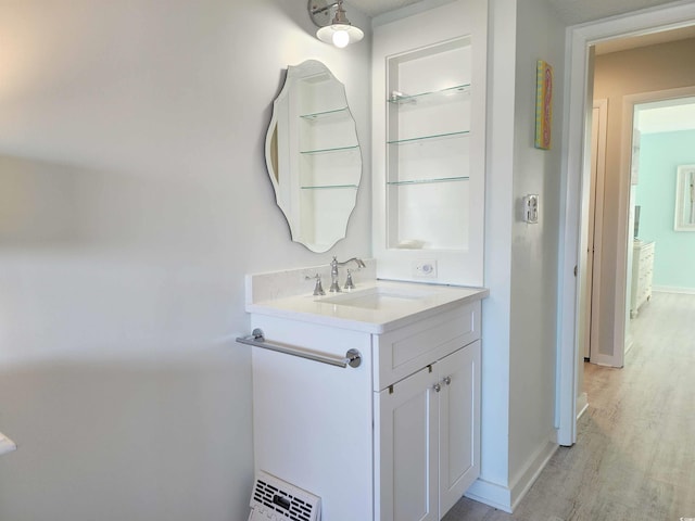 bathroom with vanity and wood-type flooring