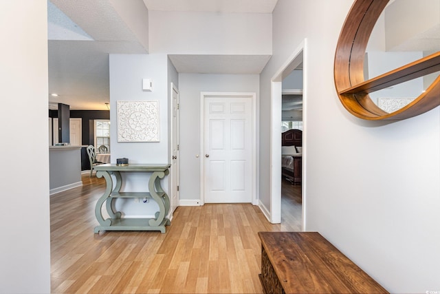 entrance foyer with light wood-type flooring and baseboards