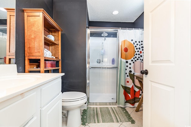 bathroom featuring toilet, tile patterned flooring, a textured ceiling, vanity, and a shower stall