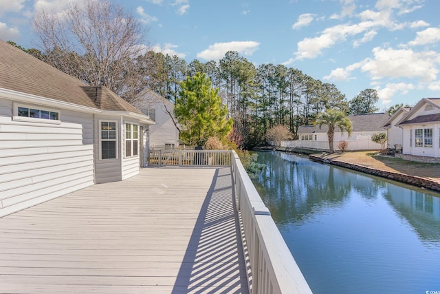 wooden terrace featuring a water view