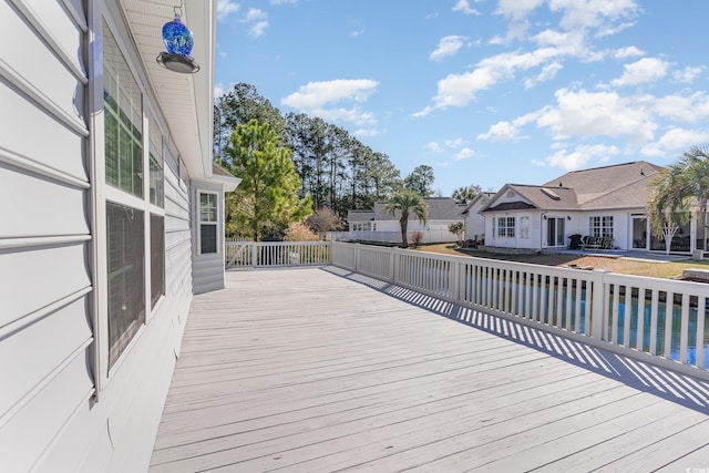 deck with a pool and a residential view