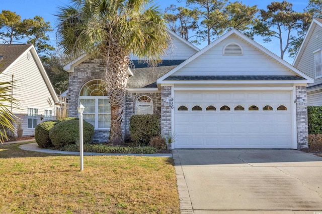 view of front of home with a garage and a front yard