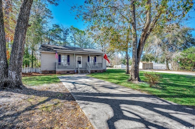 single story home with covered porch and a front lawn