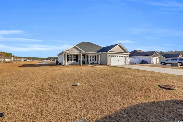 ranch-style house featuring a garage, covered porch, concrete driveway, and a front yard